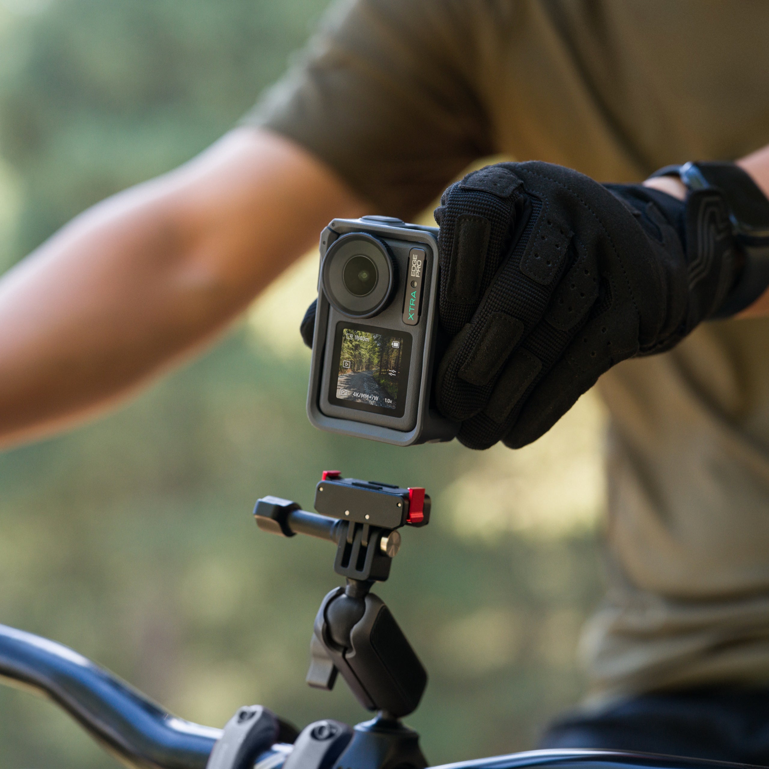 Xtra Edge Pro action camera mounted on a bike handlebar, demonstrating MotionMaster stabilization for smooth 4K/60fps cycling footage.